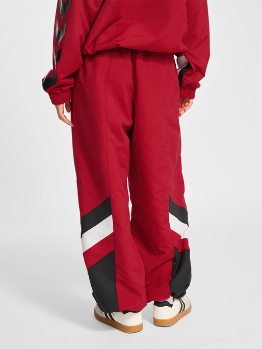 hmlTRACKSUIT PANTS DBU ROTATE, TANGO RED, model